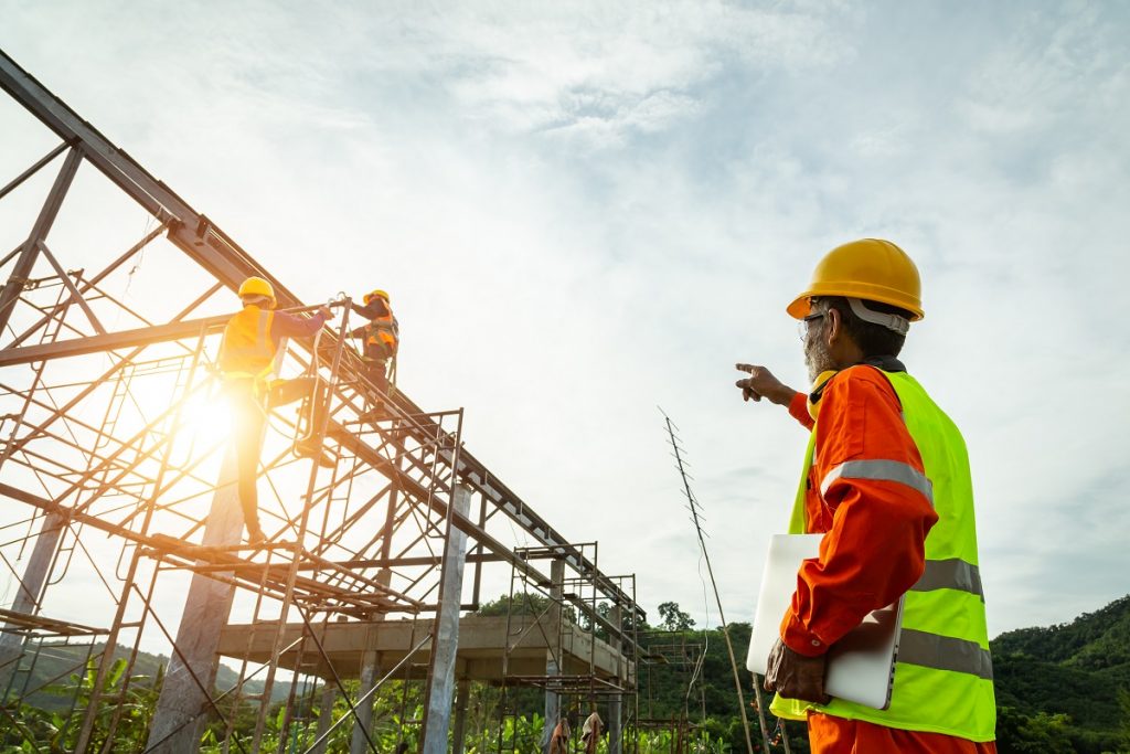 A man overseeing steel construction work