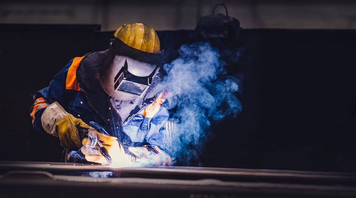 Worker welding in a factory.