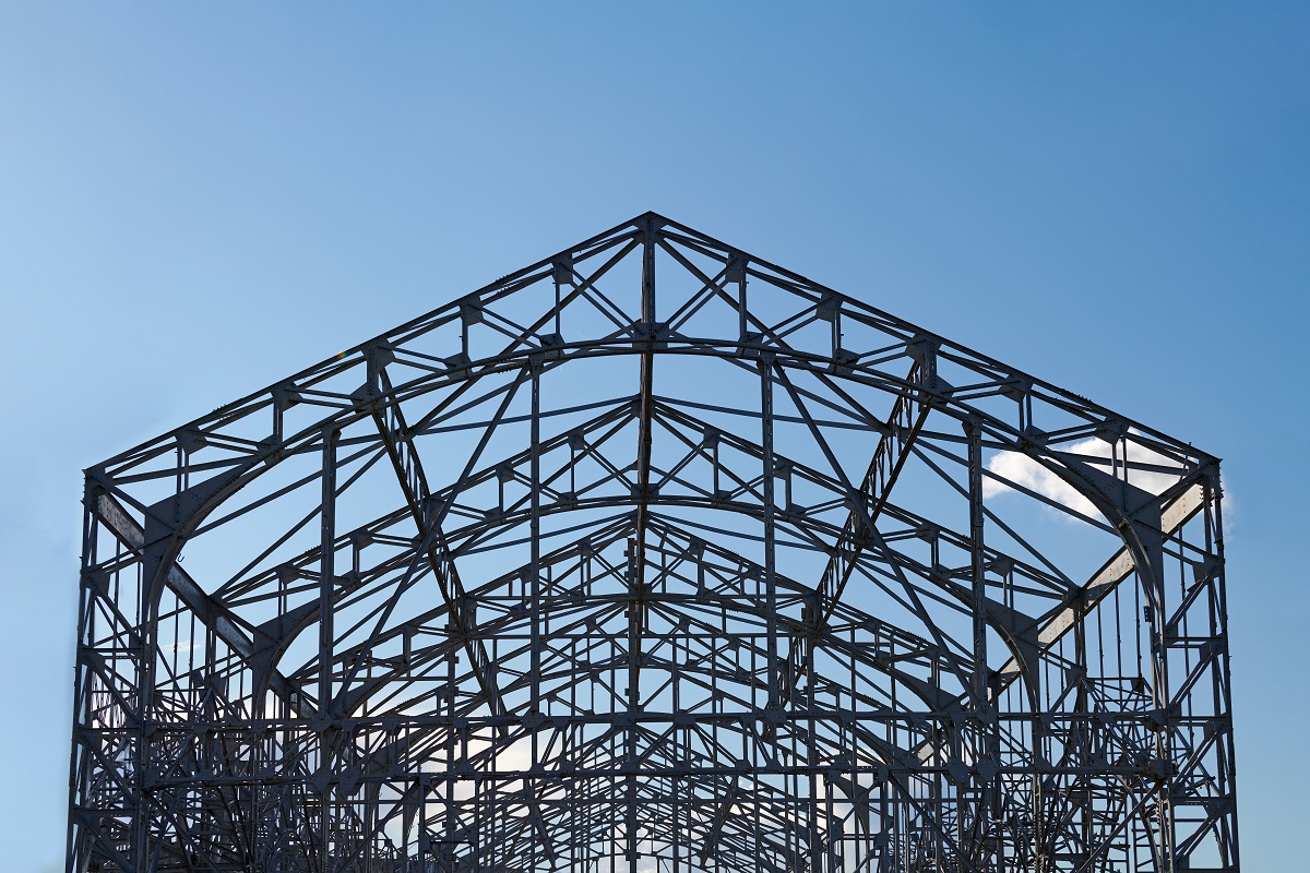 Frame of goods shed. Metal construction of railway building. Old abandoned steel warehouse for goods.