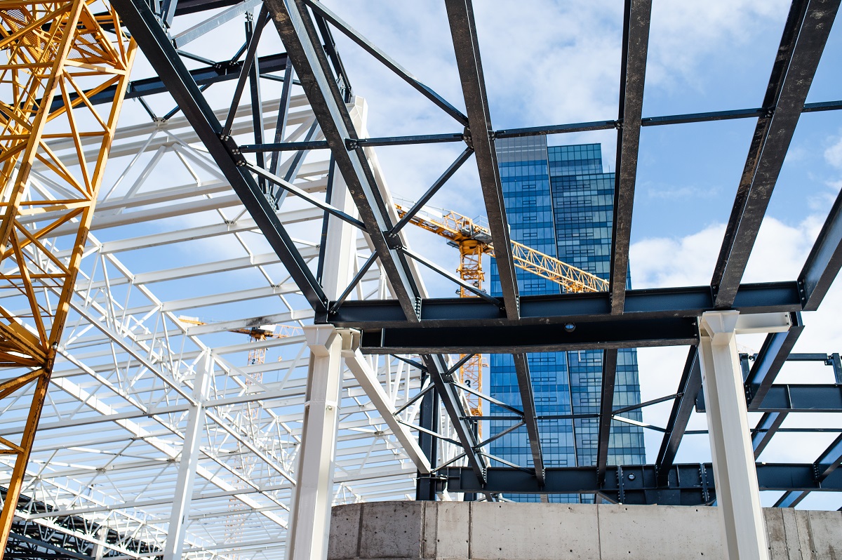 Construction site with steel frame structure and crane.