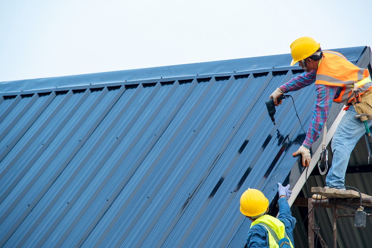 Construction worker wearing safety harness using secondary safet
