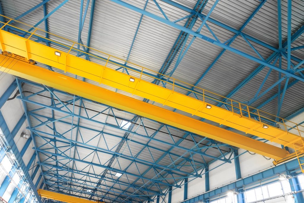 Blue steel frame of metal industrial roof in warehouse with yell