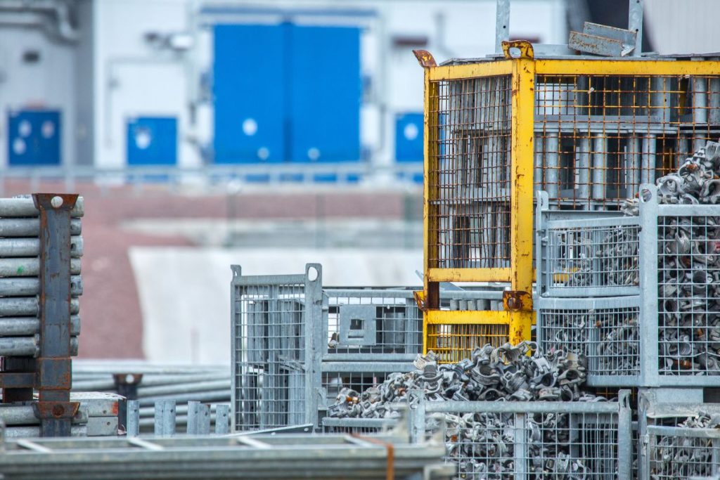Steel parts and metal hardware stored in organized site containers
