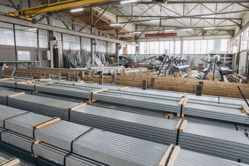Heavy steel beams organized with timber supports inside a warehouse