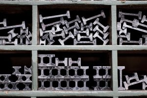 Assorted metal profiles and sections arranged in storage for construction applications