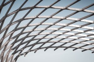 Curved architectural metal framework forming a large structural roof system
